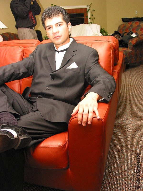 Photo of Man in Suit Sitting on Red Sofa(3085)