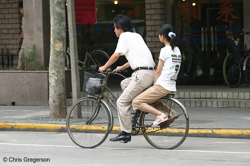 Photo of Man and Girl Sharing a Bike(3410)
