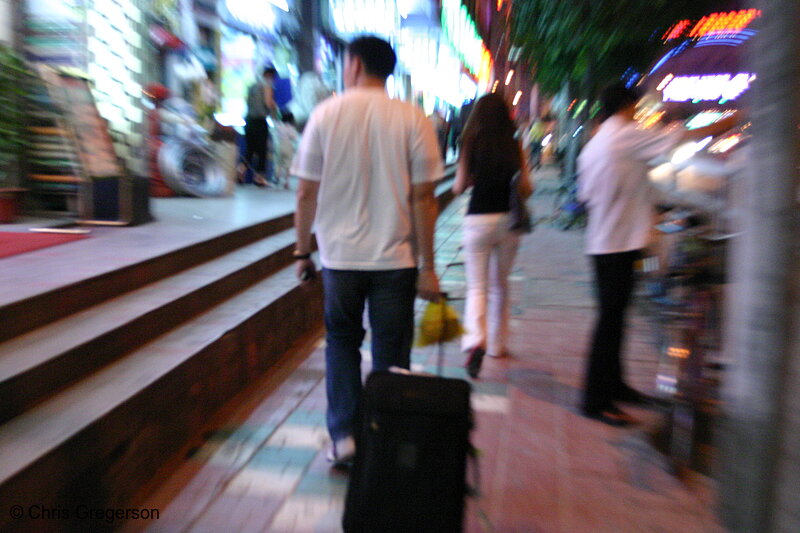Photo of Chinese Traveller with Suitcase on a Sidewalk(4205)