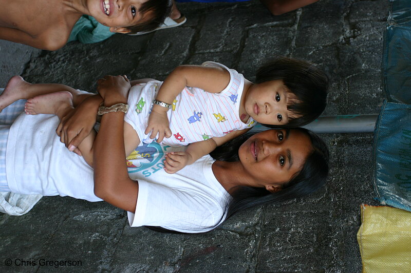 Photo of A Young Filipina Lady Carrying a Child(5375)