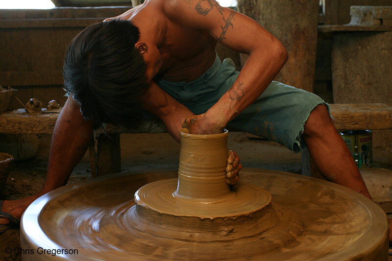 Photo of Craftworker Sculpting a Pot Using His Hand(5568)