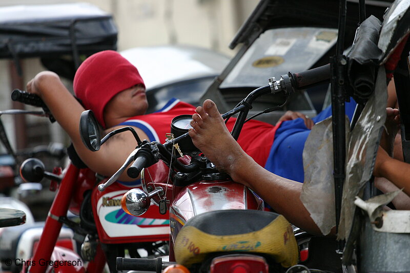Photo of Tricycle Driver Sleeping on his Motorcycle(5834)